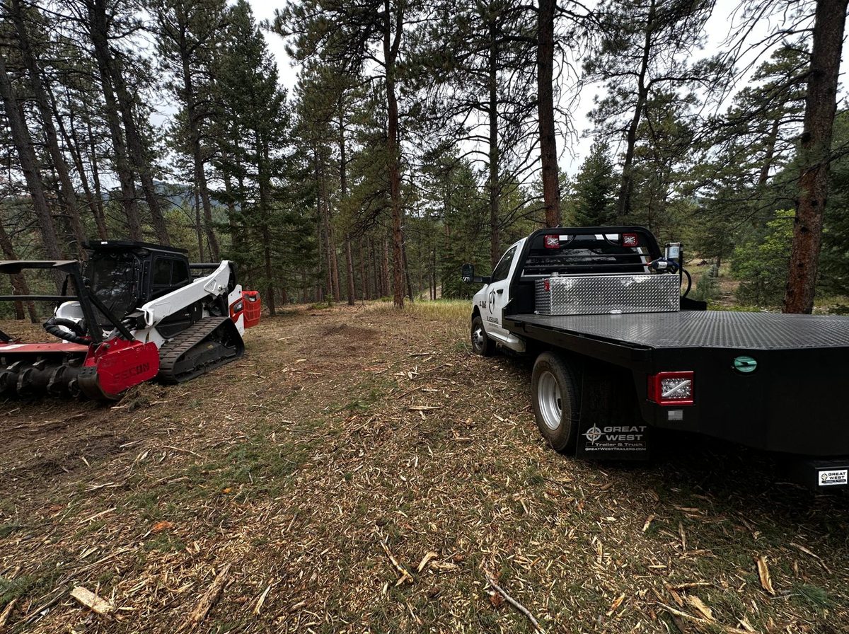 Blazeguard truck and Bobcat T86 with mulching head on a treated property in the Colorado foothills